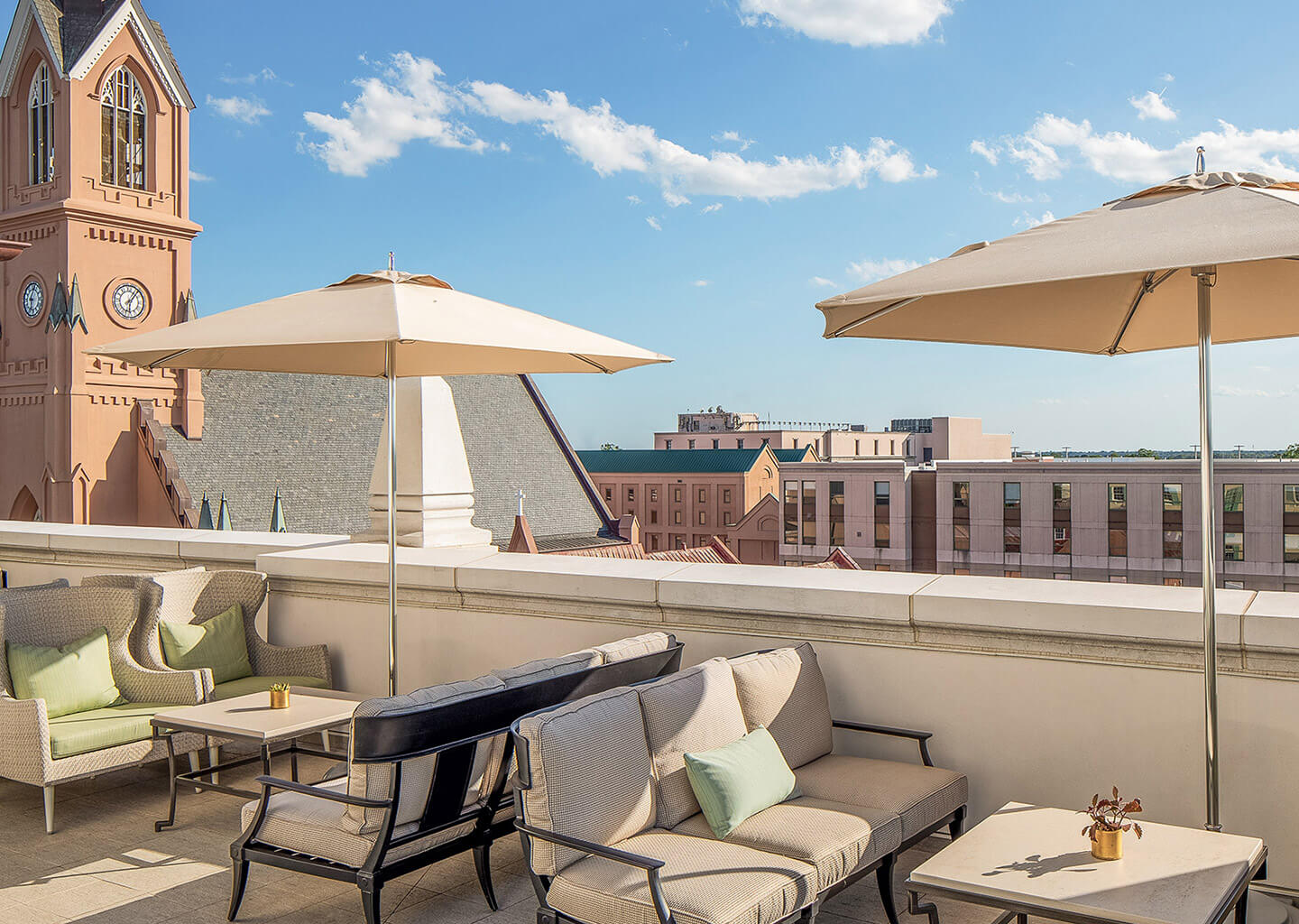 Rooftop patio with a view of Charleston and some shade umbrellas