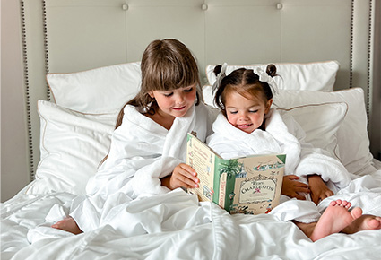 Kids reading in bed at Hotel Bennett