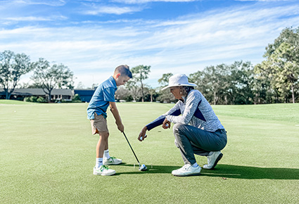 A young golfer taking golf lessons