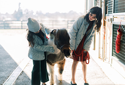 Kids playing with Cupcake the mini horse